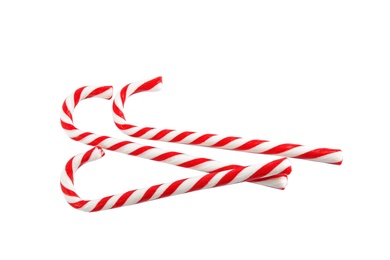 Candy canes on white background, top view. Traditional Christmas treat