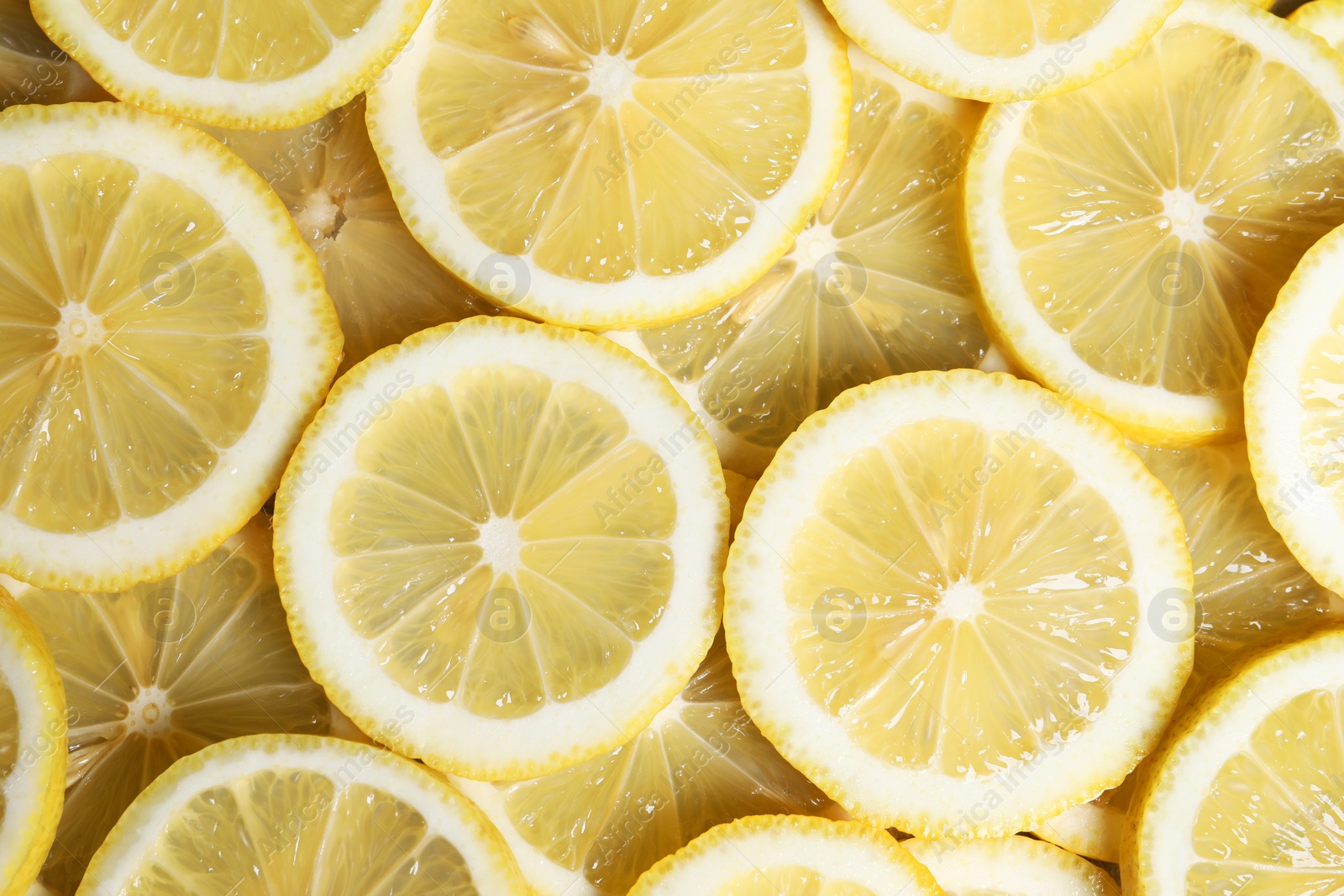 Photo of Slices of fresh lemons as background, top view