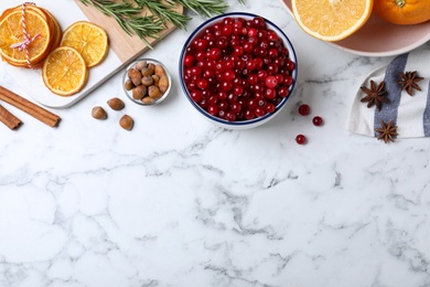Flat lay composition with fresh ripe cranberries on white marble table. Space for text