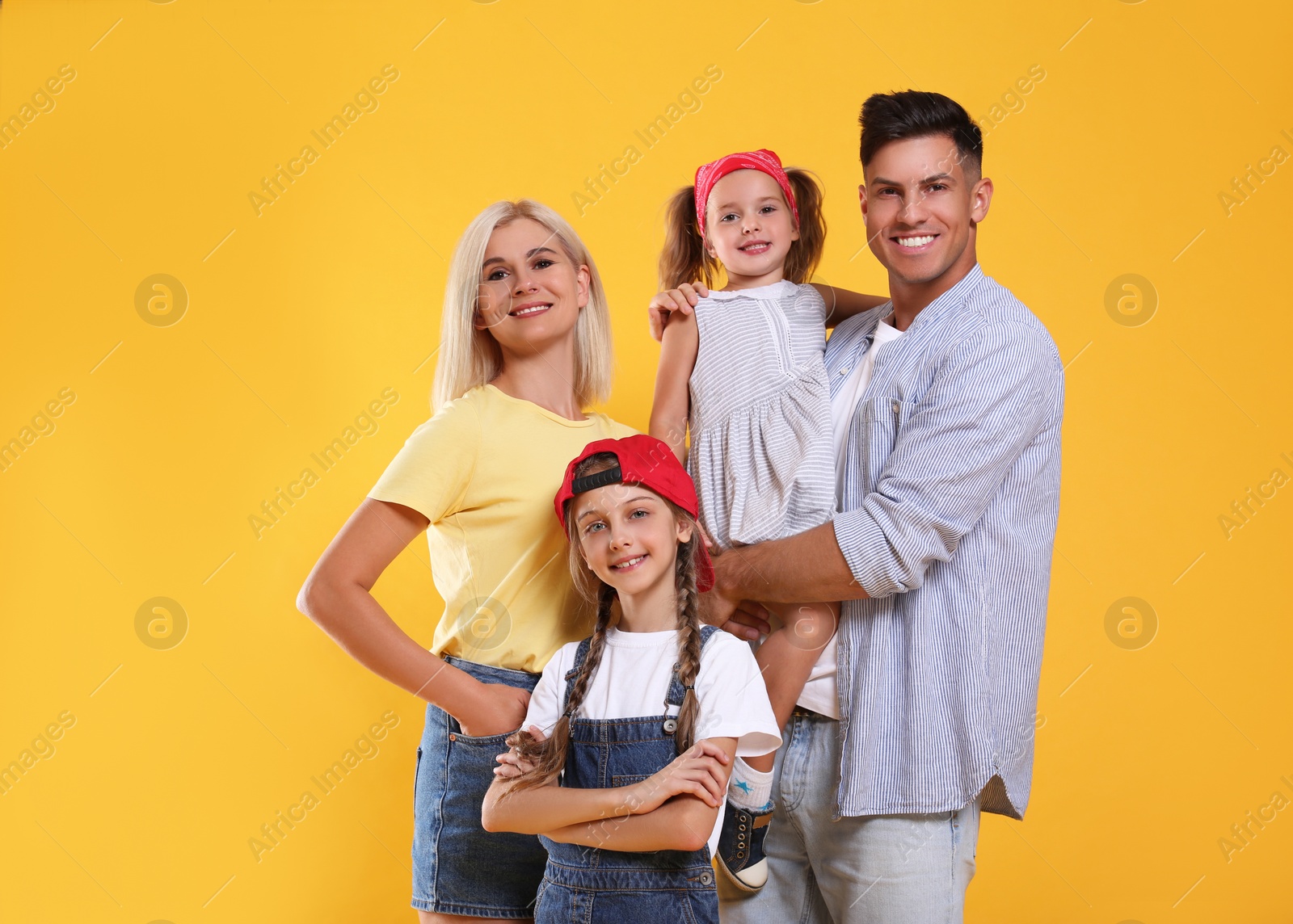 Photo of Portrait of happy family on yellow background