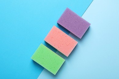 New sponges on color background, flat lay
