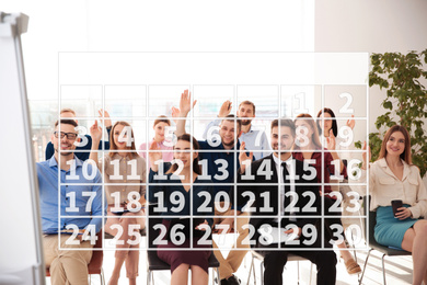 Calendar and people having business meeting indoors