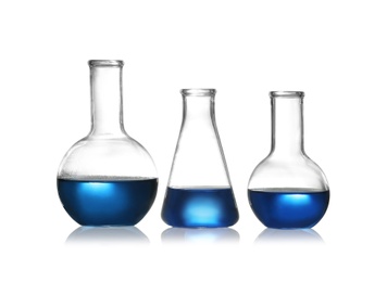 Photo of Group of chemistry glassware with liquid samples isolated on white