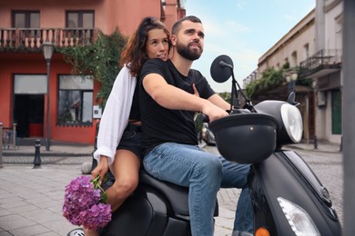 Photo of Beautiful young couple riding motorcycle on city street