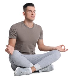 Photo of Handsome man meditating on white background. Harmony and zen