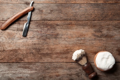 Photo of Flat lay composition with men's shaving accessories and space for text on wooden background