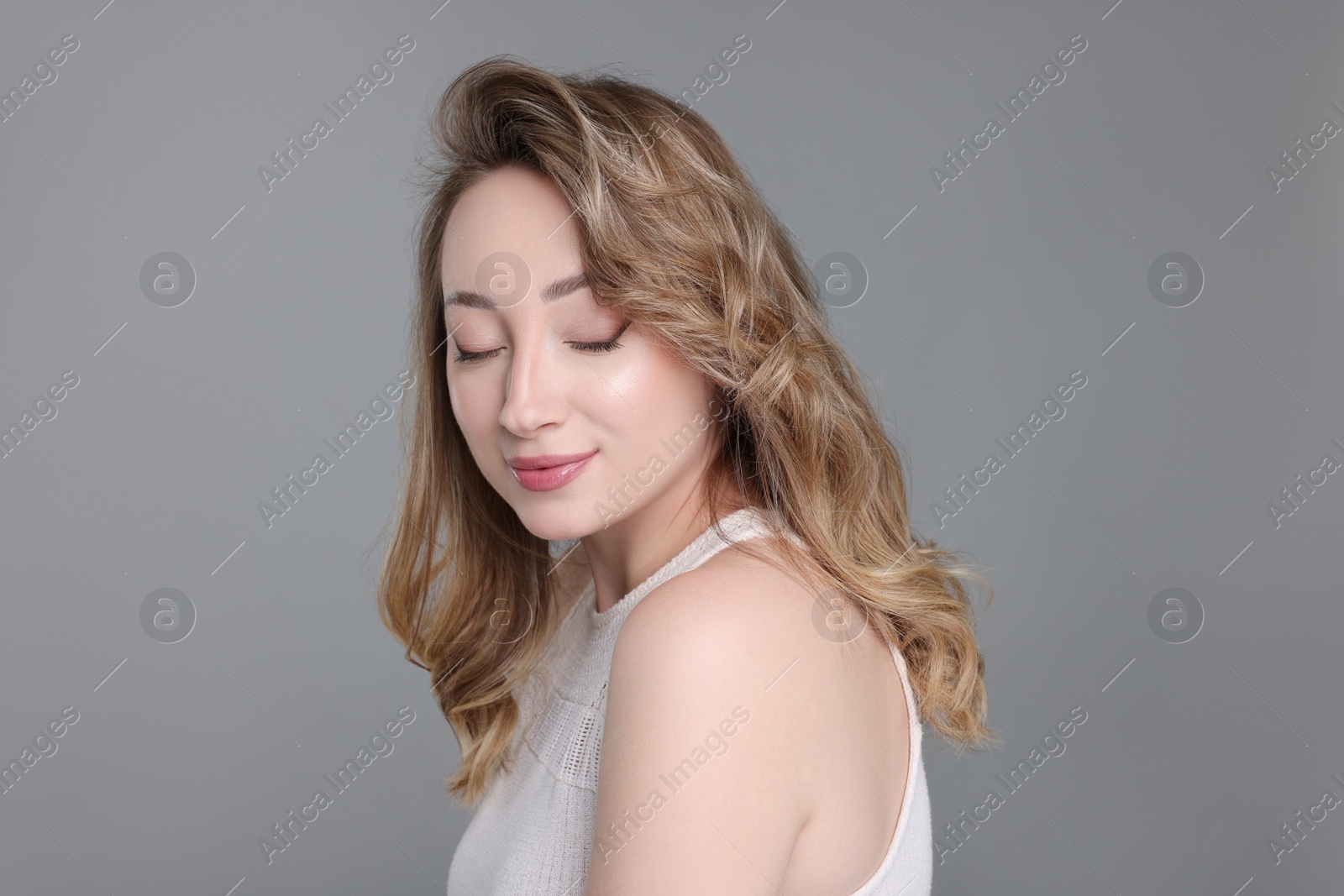 Photo of Portrait of beautiful woman on grey background