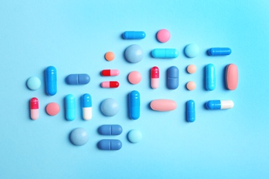 Flat lay composition with different pills on color background