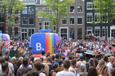 Photo of AMSTERDAM, NETHERLANDS - AUGUST 06, 2022: Many people at LGBT pride parade on summer day