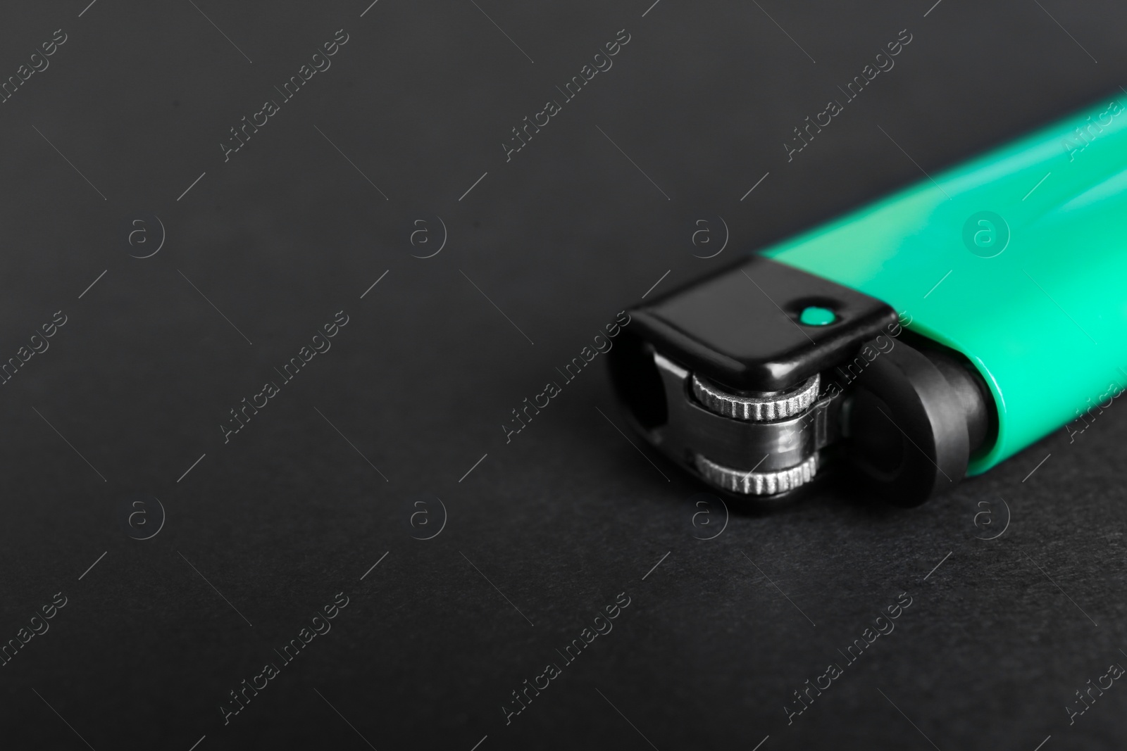 Photo of Stylish small pocket lighter on black background, closeup. Space for text