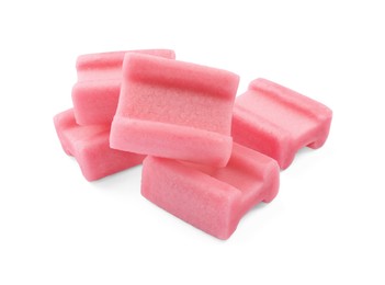 Photo of Many tasty pink chewing gums on white background