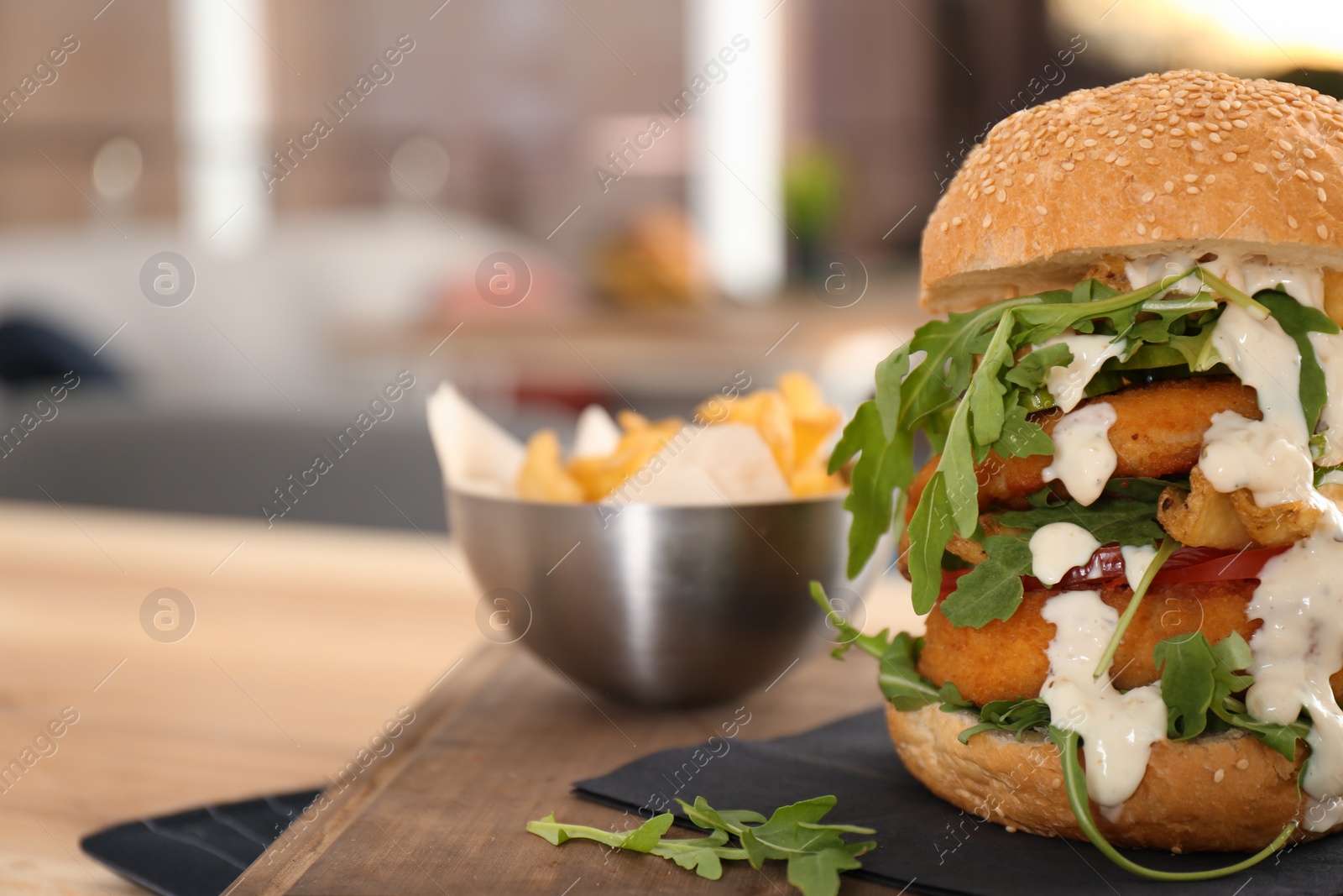 Photo of Huge yummy burger served on table in cafe. Space for text