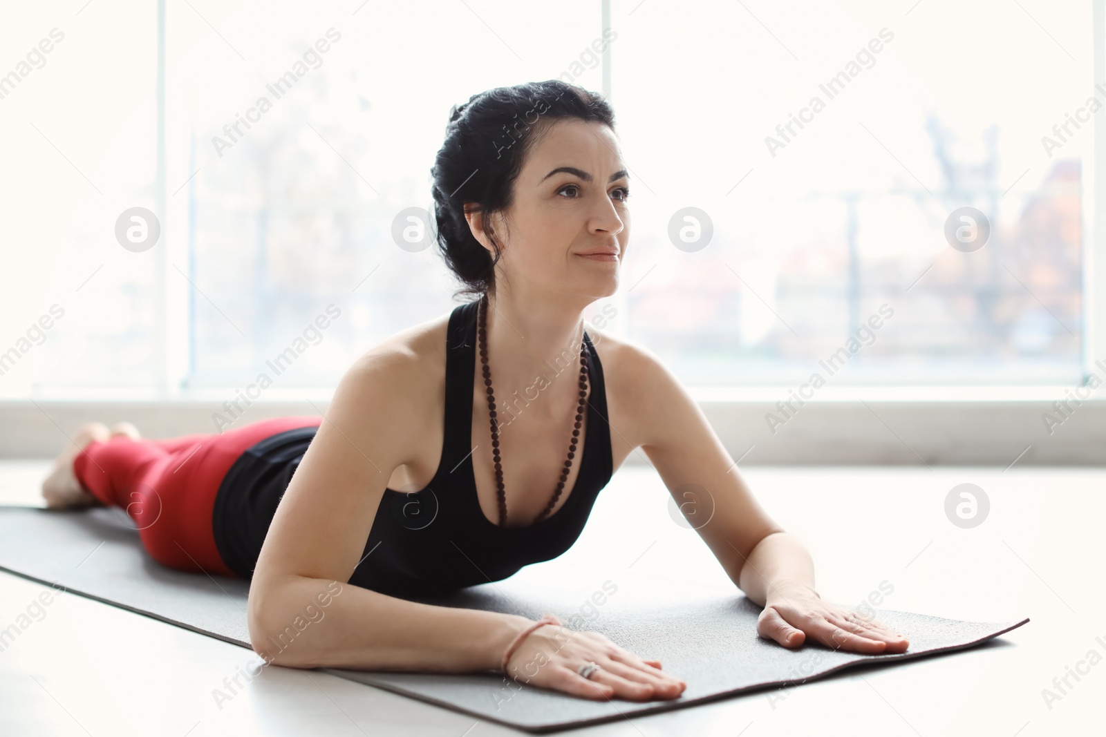 Photo of Sporty woman practicing yoga indoors