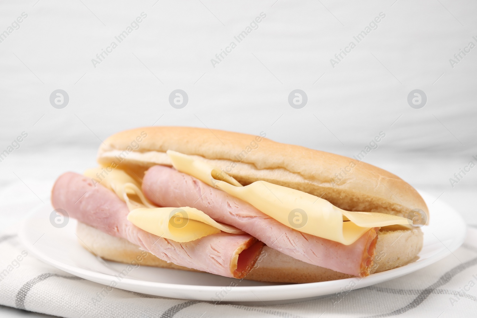 Photo of Delicious sandwich with ham and cheese on table, closeup