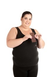 Overweight woman with chocolate bar on white background