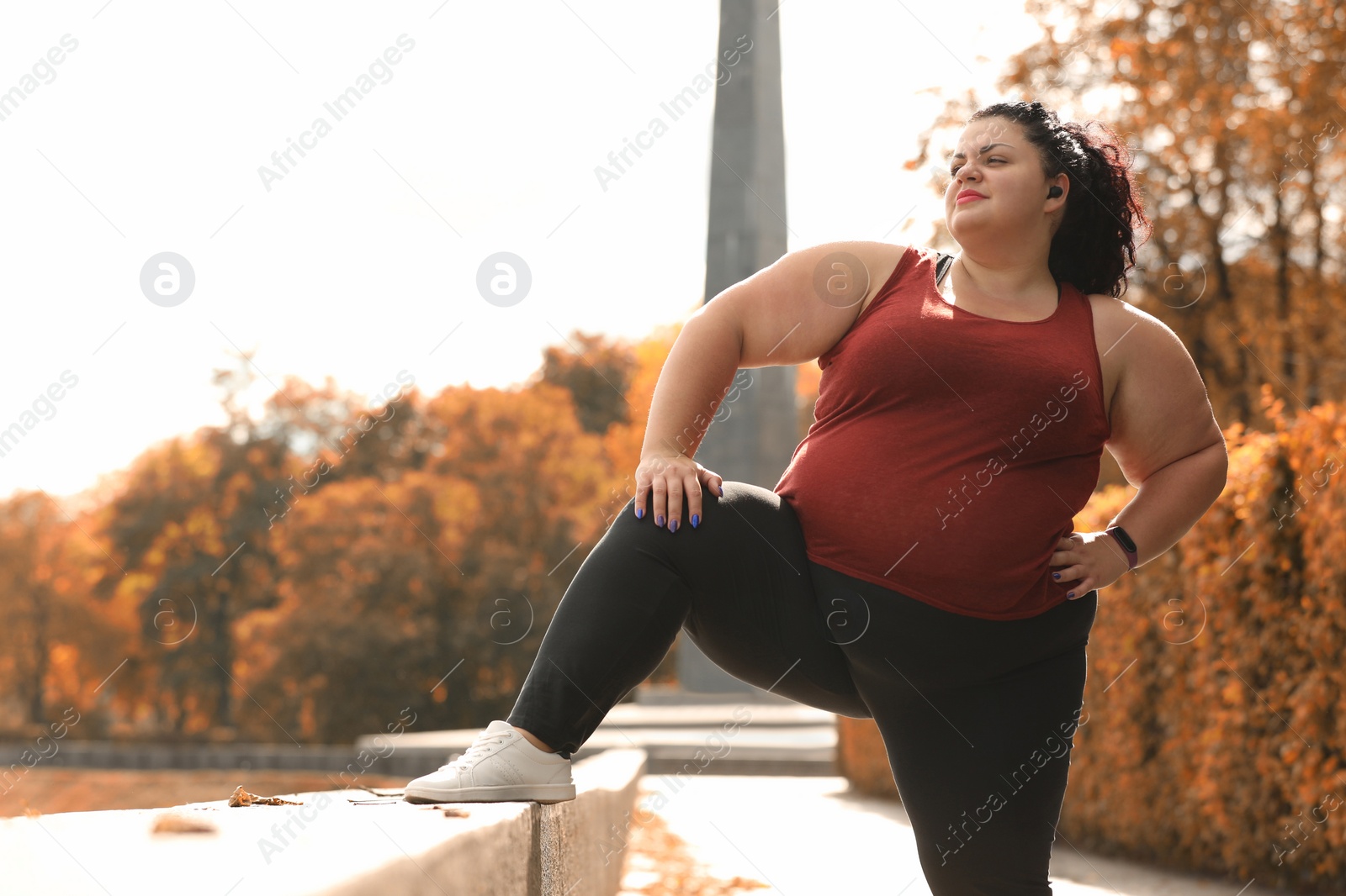 Photo of Beautiful overweight woman doing sport exercises in park