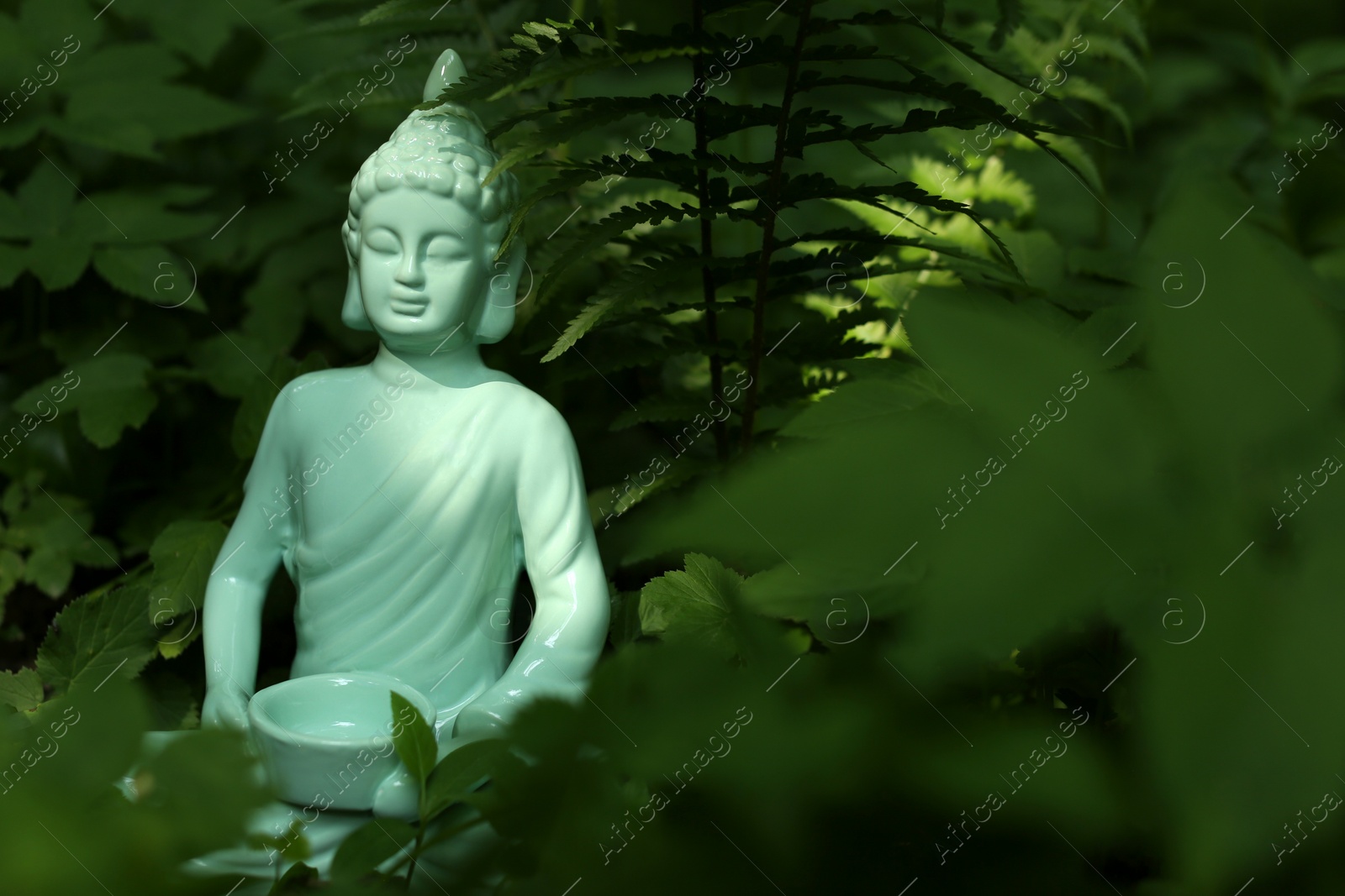 Photo of Decorative Buddha statue outdoors. Space for text