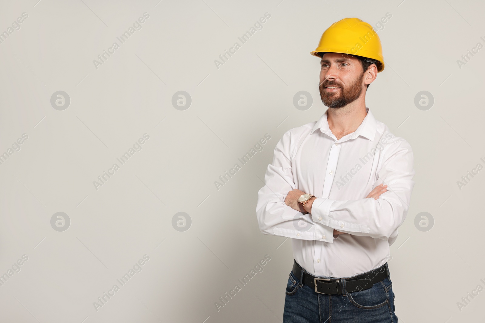 Photo of Professional engineer in hard hat on white background, space for text