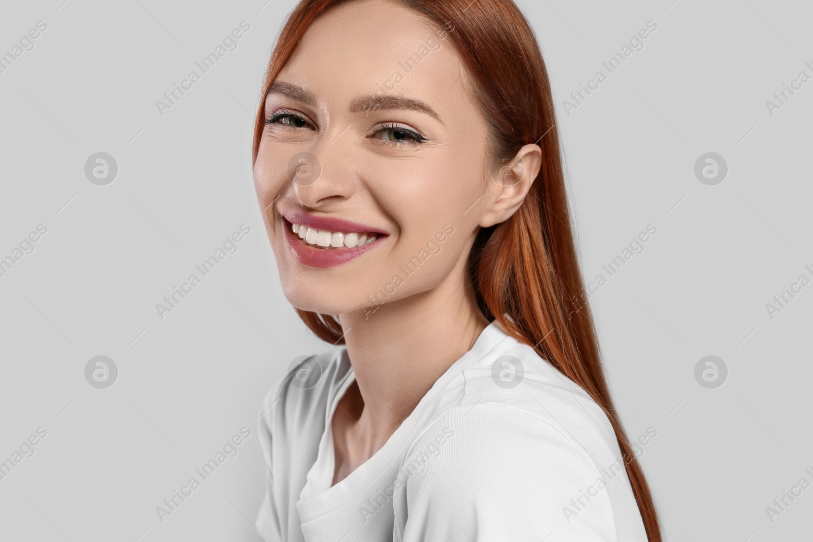 Photo of Portrait of beautiful young woman on light gray background