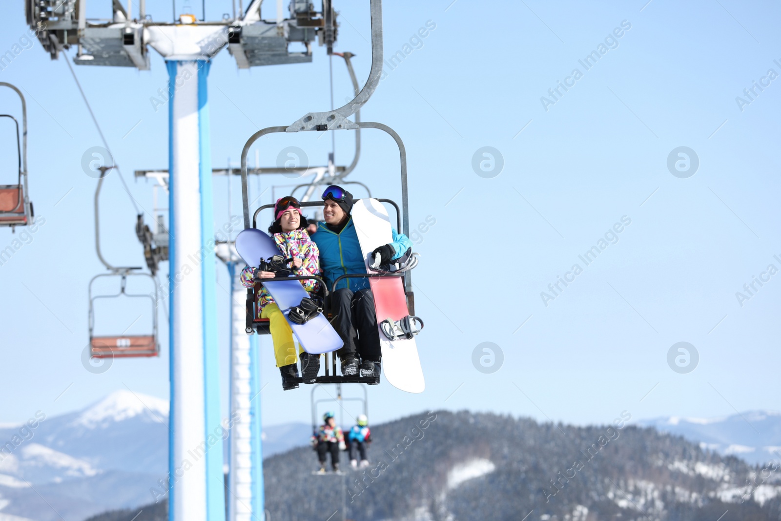 Photo of People using chairlift at mountain ski resort. Winter vacation