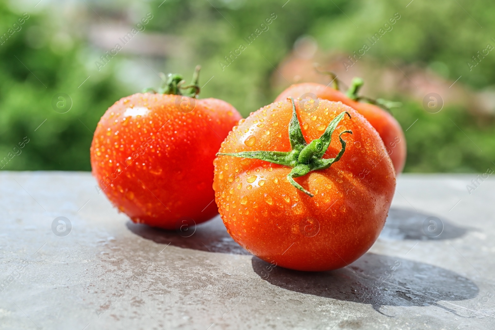 Photo of Fresh ripe tomatoes on table outdoors