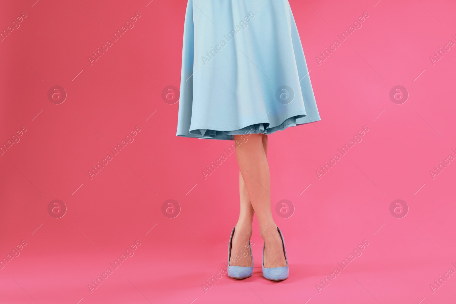 Photo of Woman in elegant shoes on pink background