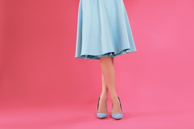 Photo of Woman in elegant shoes on pink background