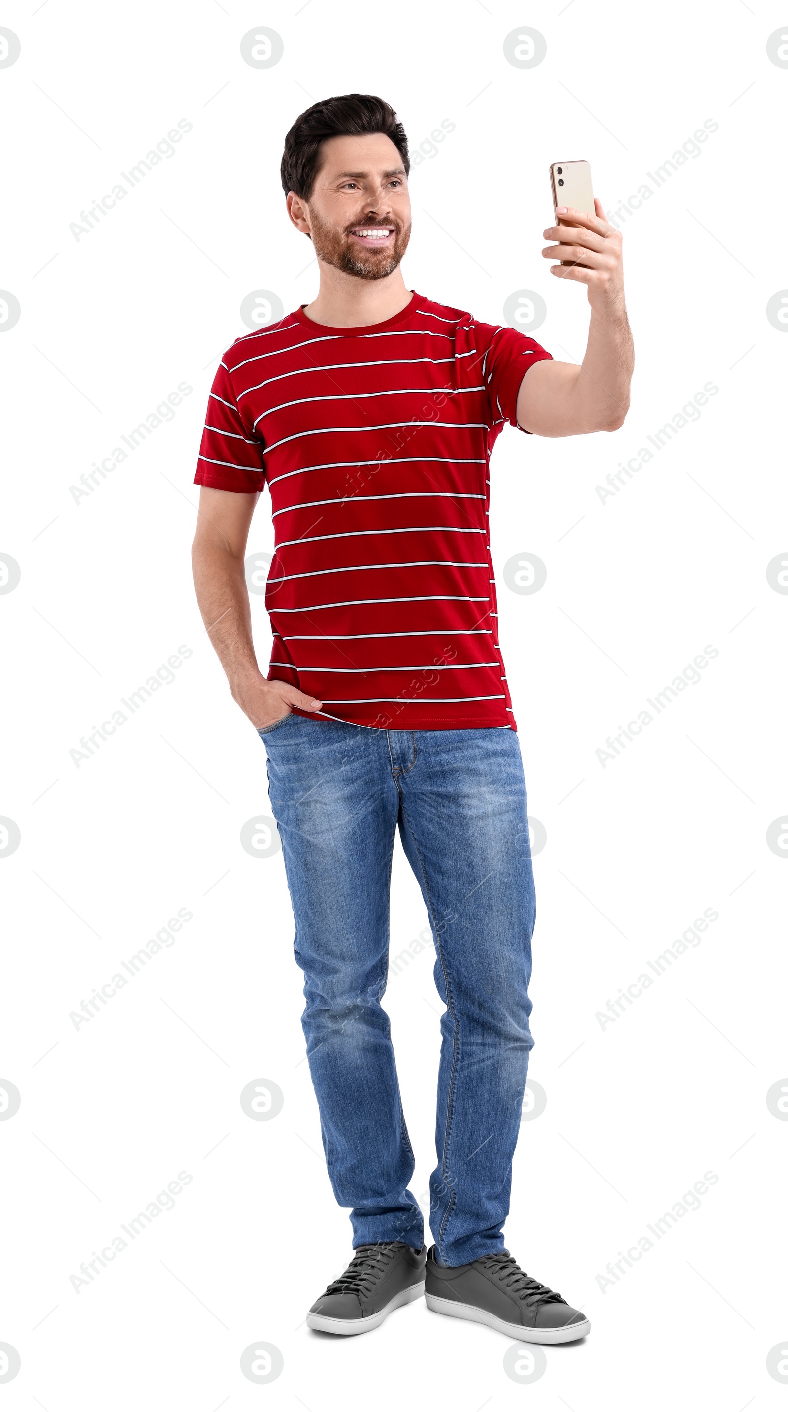 Photo of Smiling man taking selfie with smartphone on white background