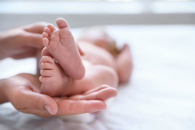 Photo of Mother and her newborn baby on bed, closeup. Space for text