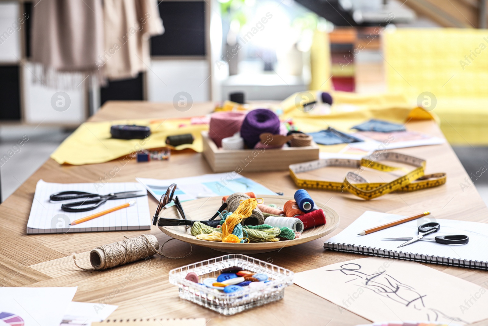 Photo of Fashion designer's workplace in studio. Creating new clothes