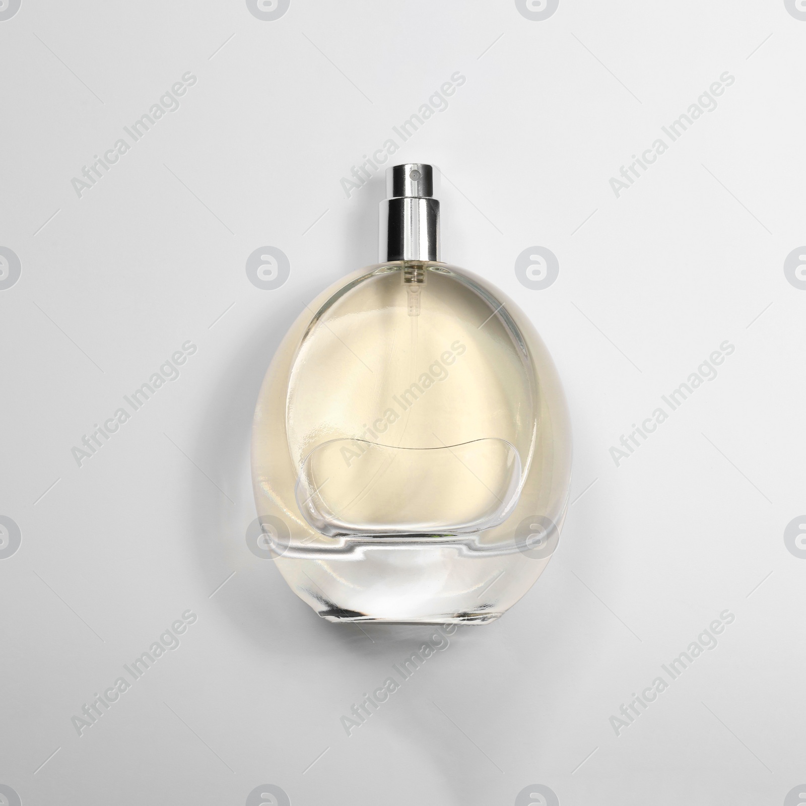 Photo of Luxury women's perfume in bottle on white background, top view