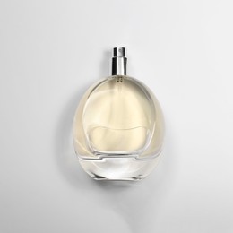 Photo of Luxury women's perfume in bottle on white background, top view