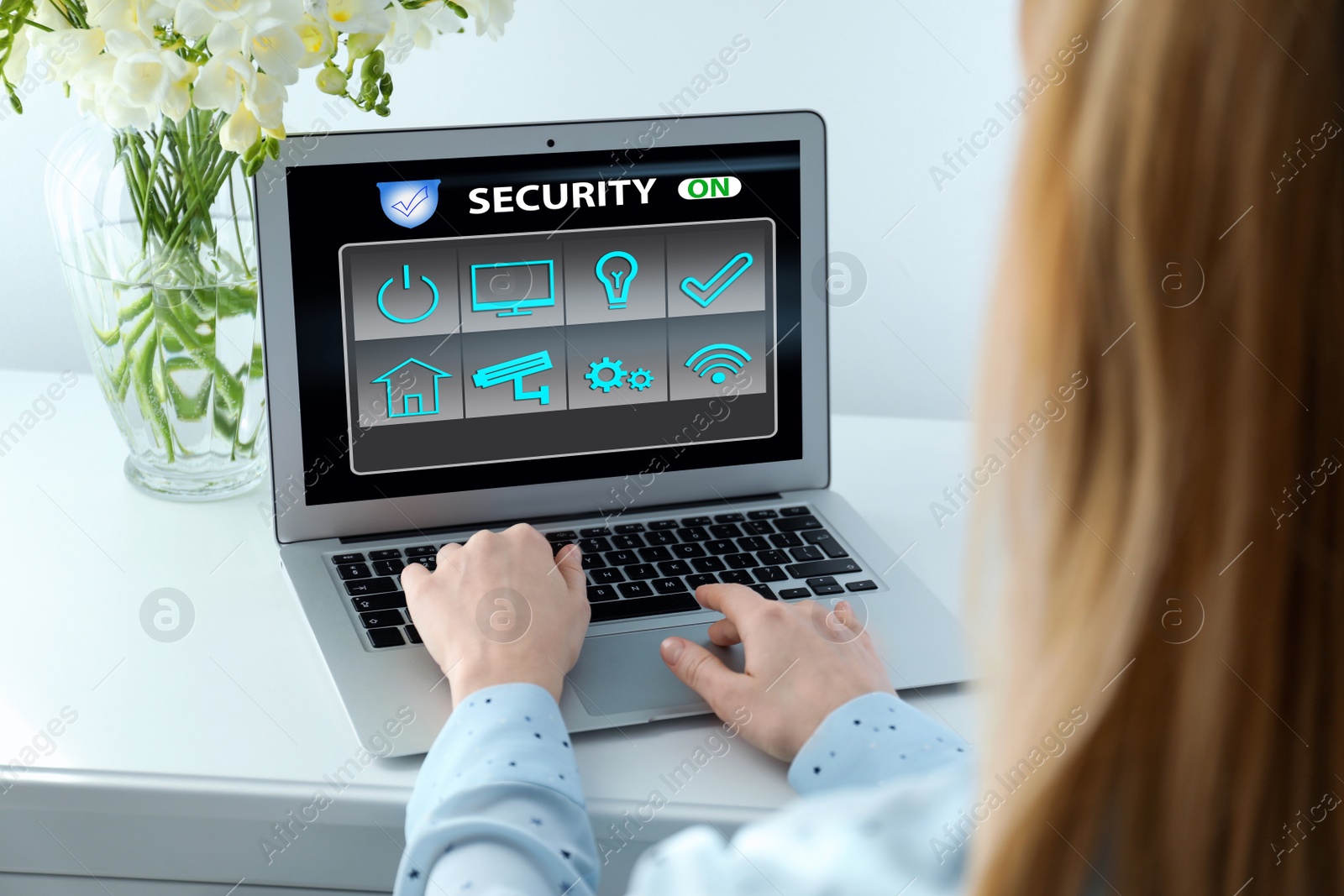 Image of Woman using home security app indoors, closeup