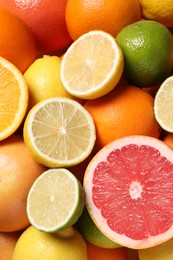 Photo of Different fresh citrus fruits as background, above view