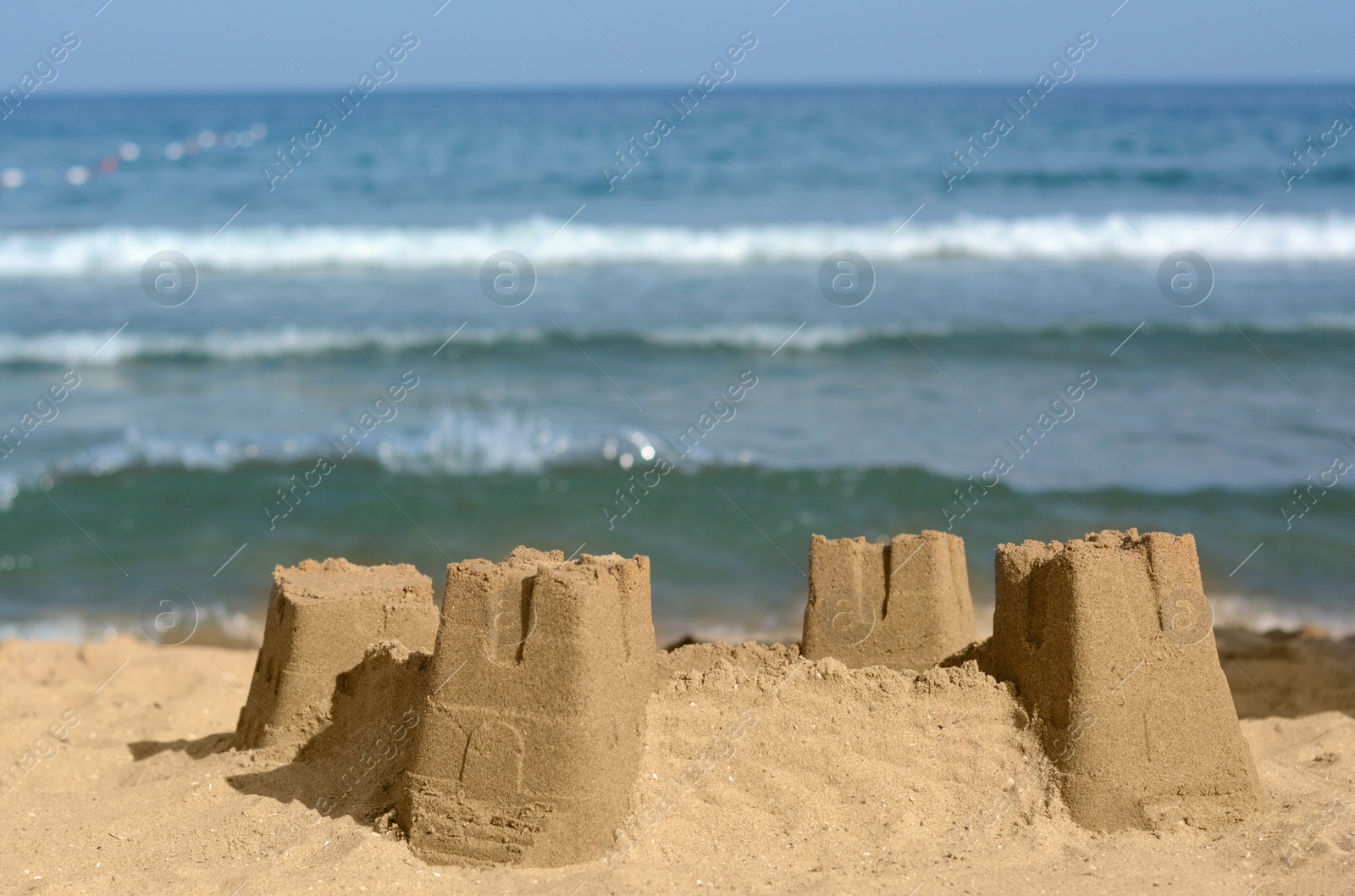 Photo of Beautiful sand castle on beach near sea