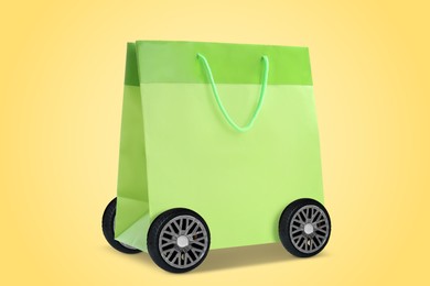 Image of Green shopping bag on wheels against yellow background. Delivery service