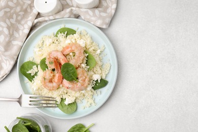 Photo of Delicious couscous with shrimps and spinach served on white table, flat lay. Space for text
