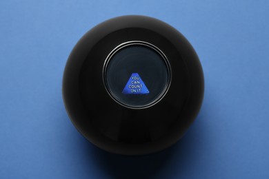 Magic eight ball with prediction You Can Count On It on blue background, top view