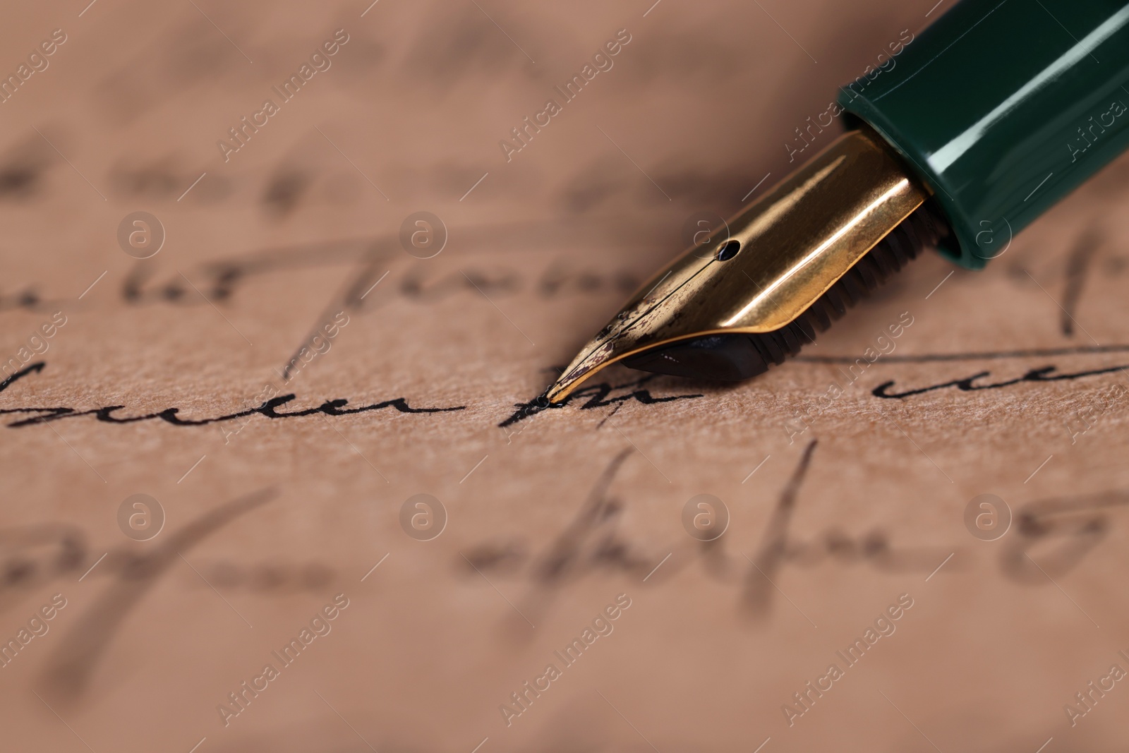 Photo of Writing letter with elegant fountain pen, closeup