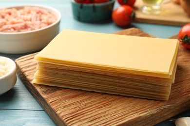 Ingredients for lasagna on blue wooden table, closeup