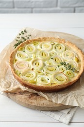 Tasty leek pie with thyme on white wooden table