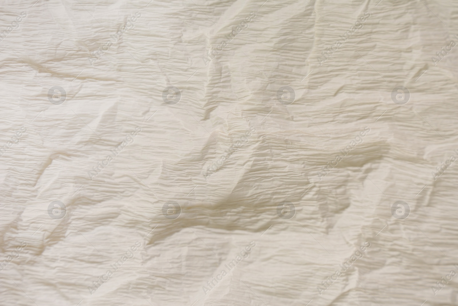 Photo of Texture of crumpled beige paper as background, closeup view