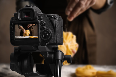 Image of Food photography. Shooting of woman making pasta, focus on camera