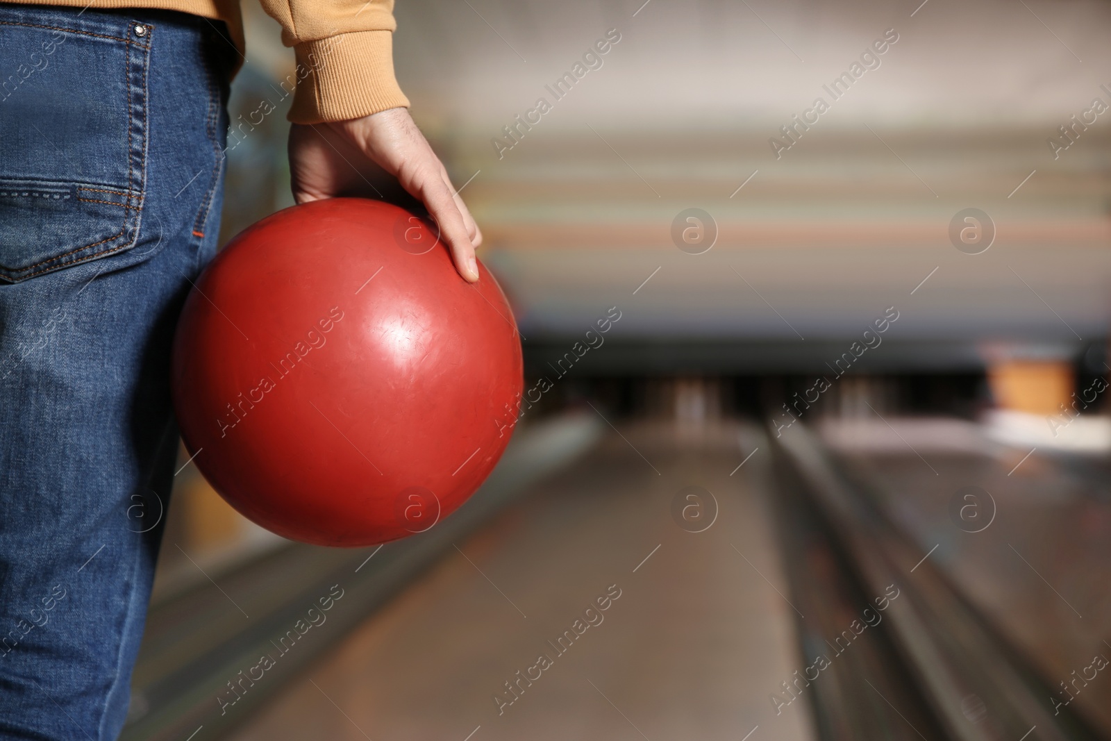 Photo of Man with ball in bowling club, closeup. Space for text