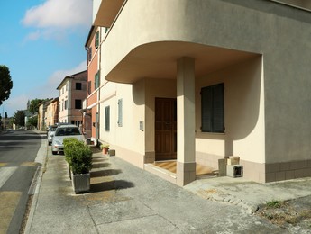 Photo of Many beautiful buildings and cars near crosswalk outdoors