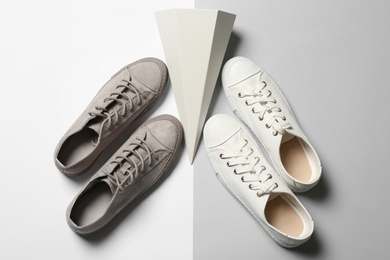 Photo of Flat lay composition with different sneakers on color background