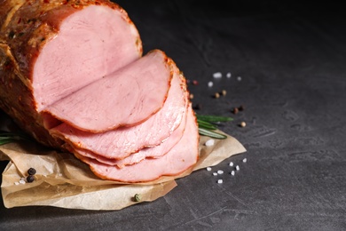 Delicious ham on grey table, space for text. Christmas dinner