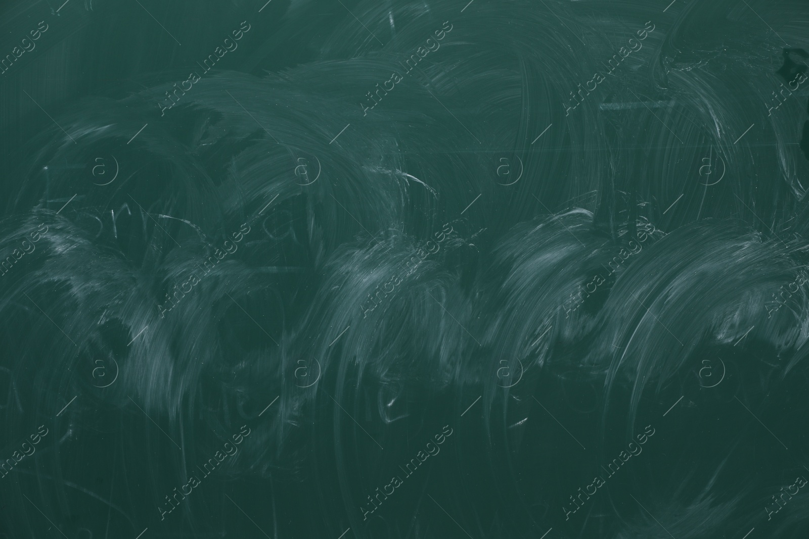 Photo of Chalk rubbed out on green chalkboard as background, closeup. Space for text