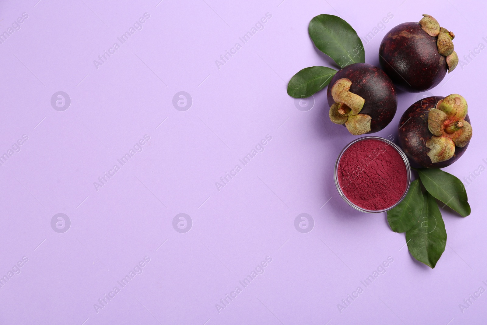 Photo of Mangosteen powder and fruits on violet background, flat lay. Space for text