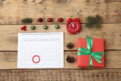 Flat lay composition with calendar and gift on wooden background. Boxing Day